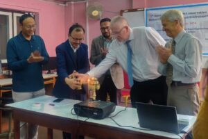 Dr Novak, Center, lights a panas lamp. Dr Kyes, retired chief of the WaNBRC GP unit is to the right.